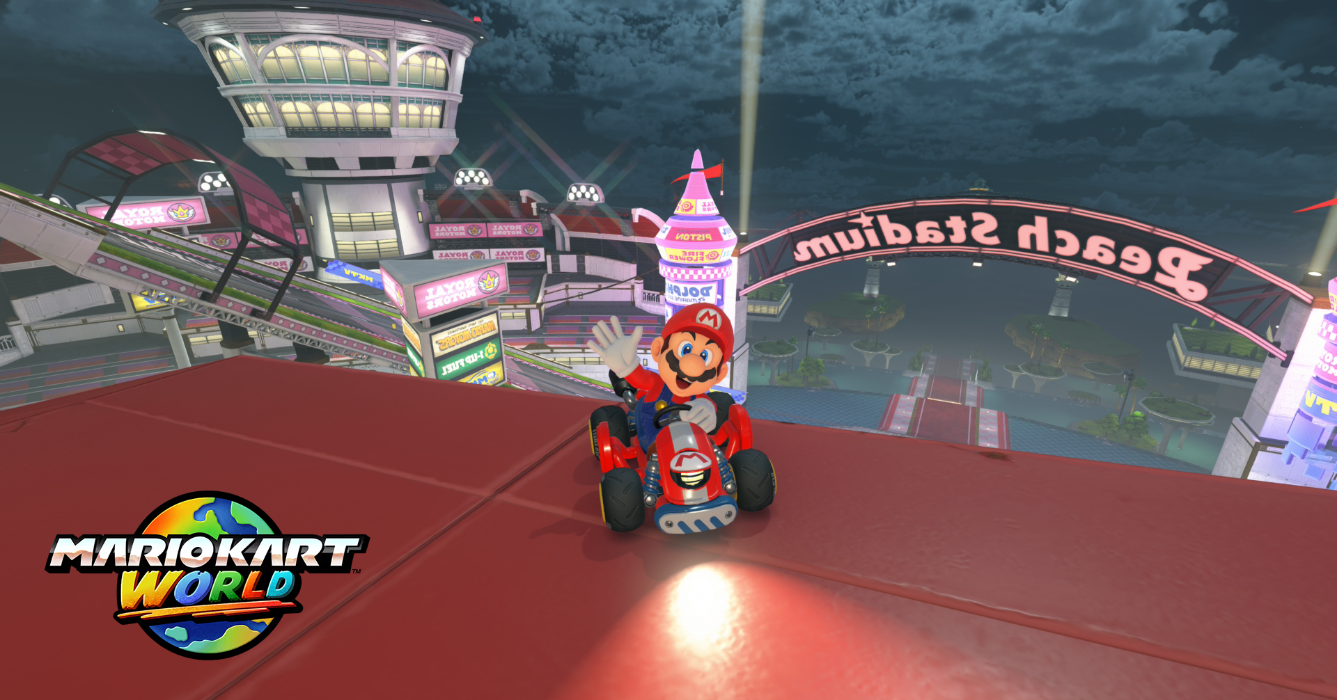 mario kart world capture d'écran montrant Mario dans son lart en train de faire coucou à la caméra